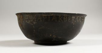 A BYZANTINE BRONZE BOWL, the rim with incised inscription. 7ins diameter.