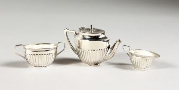 A MINIATURE SILVER THREE PIECE TEA SET.