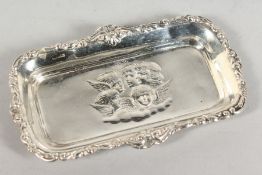 A SILVER PIN TRAY repousse with cupids.