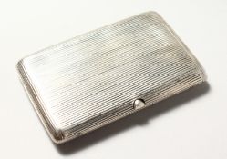 A RUSSIAN SILVER CIGARETTE CASE, with ribbed decoration. 4ins x 2.5INS.