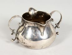 A GEORGE II SILVER TWIN HANDLED BRANDY WARMER. London 1736. Maker I. G. 4.5ins wide.