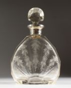 A FINELY ENGRAVED DECANTER AND STOPPER with silver band.