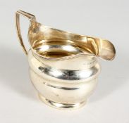 A GEORGE III SILVER MILK JUG with reeded edge and handle. London 1806. Maker Andrew Fogelberg.
