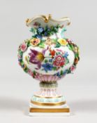 A GOOD 19TH CENTURY MEISSEN FLOWER ENCRUSTED URN painted with flowers on a square base. Crossed