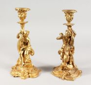 A PAIR OF LOUIS XVITH GILDED METAL CLASSICAL CANDLESTICKS of a nude female and a young boy on a