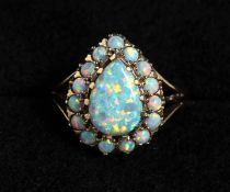 A 9CT GOLD TEAR DROP GILSON OPAL RING.