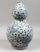 A CHINESE BLUE AND WHITE DECORATED DOUBLE GOURD PORCELAIN VASE. 15ins high.