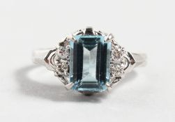 A GOOD PLATINUM AND AQUAMARINE RING with diamond shoulders.