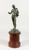 A NEAPOLITAN BRONZE BUST OF NARCISSUS on a circular base. 11ins high on a wooden plinth. 17.5ins