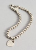 A TIFFANY & CO SILVER BRACELET in a Tiffany & Co box.