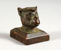 A BRONZE MINIATURE MONKEY HEAD SEAL. 1.25ins wide.