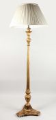A GILTWOOD STANDARD LAMP, with carved and fluted decoration, on a concave sided base with cream