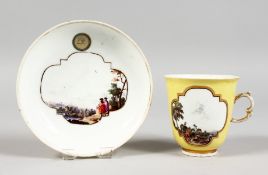 A GOOD 18TH CENTURY MEISSEN PORCELAIN YELLOW GROUND CUP AND SAUCER, the cup with two scenes of