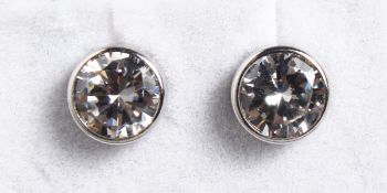 A PAIR OF 9CT GOLD AND ZIRCON STUDS.