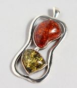 A SILVER AND AMBER PENDANT. 2.5ins high.