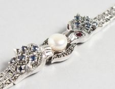 A GOOD SILVER AND SAPPHIRE PANTHER BRACELET with a large pearl.