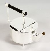 IN THE MANNER OF CHRISTOPHER DRESSER, a silver plated circular teapot.