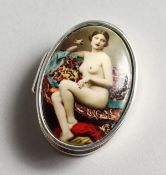 AN OVAL SILVER PILL BOX, the top with an enamel of a nude.