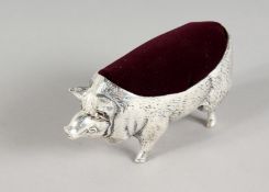 A LARGE PIG PIN CUSHION. 4ins long.