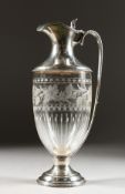 A CONTINENTAL SILVER MOUNTED CUT GLASS CLARET JUG. 11ins high.