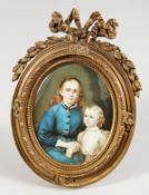A 19TH CENTURY FRENCH OVAL PORTRAIT MINIATURE OF A MOTHER AND CHILD in an ormolu easel frame.