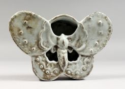 A CHINESE WHITE GLAZED POTTERY BUTTERFLY SHAPE BRUSH WASHER. 7.75ins wide.