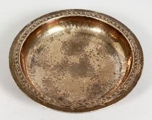 A LIBERTY & CO. SILVER HAMMERED DISH on four bun feet. 5.5ins diameter. Birmingham 1935.