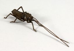A JAPANESE BRONZE MINIATURE ARTICULATED LOCUST. 5ins long.