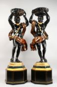A GOOD PAIR OF CARVED WOOD AND PAINTED BLACKAMOOR FIGURES ON STANDS, each depicting a male figure