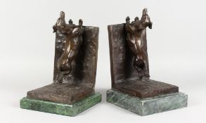 TWO AMUSING BRONZE AND MARBLE DACHSHUND BOOKENDS. Each 12ins long.