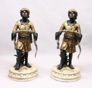 A PAIR OF COLOURFUL BLACKAMOOR STICK STANDS.