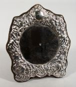 A SILVER CIRCULAR PHOTOGRAPH FRAME. 6.5ins x 5.5ins.