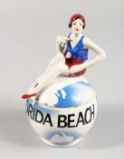 A MATCHING ART DECO STYLE POT AND COVER, the lid with a female swimmer. 3ins high.