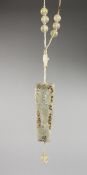 AN UNUSUAL GOLD MOUNTED CHINESE PIERCED JADE PENDANT, on a beaded cord necklace. Plaque 3ins long.