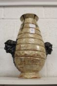 An unusual continental vase, the handles formed as human heads.