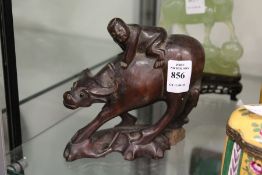 A Chinese carved wood figure of a boy on a water buffalo.