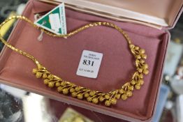 A decorative gilt metal necklace, boxed.