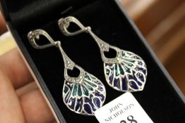 A pair of silver and enamel earrings.