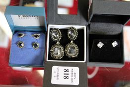 Four pairs of decorative earrings.