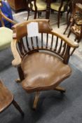 An Edwardian mahogany swivel armchair.