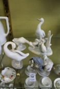 Five Lladro and Nao porcelain groups of geese.