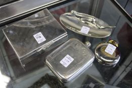 A cigarette box, an ornate cast metal dish and two hip flasks.