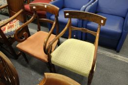 Two 19th century mahogany dining chairs with arms.