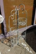 A wrought iron folding plant pot stand.