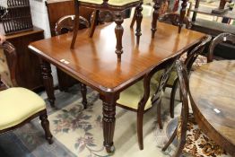 A good Victorian style mahogany extending dining table with one leaf.