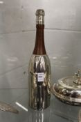 A novelty cocktail shaker in the form of a champagne bottle.