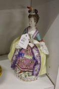 A continental porcelain figure of a lady carrying a fan.