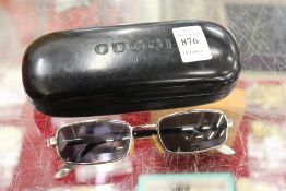 A pair of Gucci sunglasses, boxed.