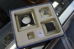 A cased gift set, including a candle holder and place name holder.