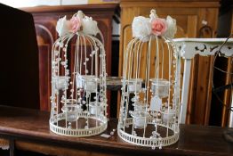 A pair of bird cage style tea light holders.